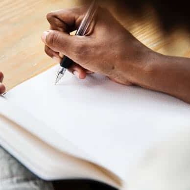 hand writing on paper in office